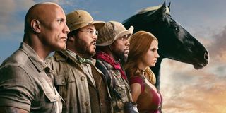 Jumanji: The Next Level the cast (and a horse) line up in front of a dusky sky