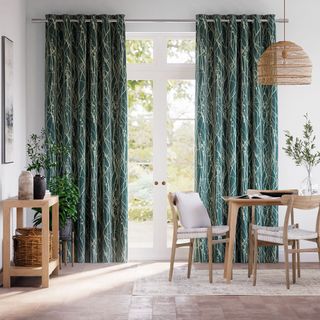 green and white patterned curtains over door in dining area