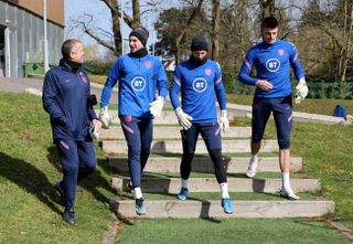 Martyn Margetson, England goalkeeping coach, Sam Johnstone, Dean Henderson and Nick Pope of England walk out prior to the England Training Session ahead of the FIFA World Cup 2022 Qatar Qualifier against Albania at Pennyhill Park on March 27, 2021 in Bagshot, England