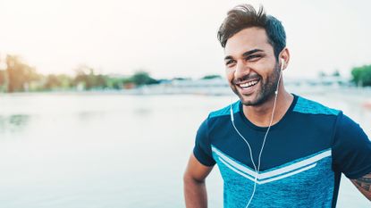 Man smiles as he exercises outside