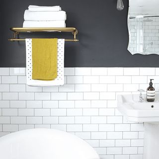 bathroom with white tiles and towel