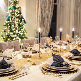 Christmas table setting in navy and gold