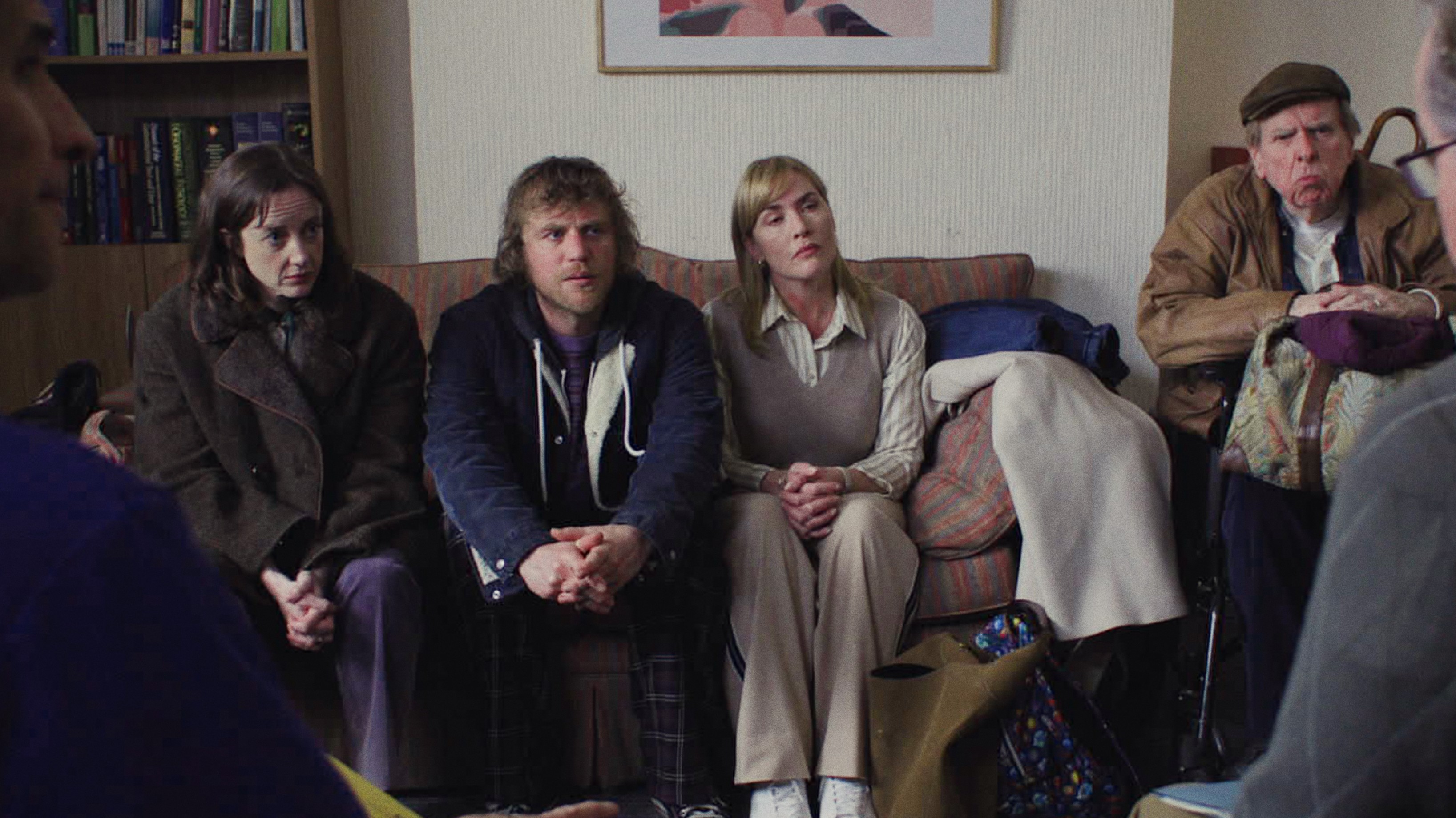 L-R: Andrea Riseborough, Johnny Flynn, Kate Winslet and Timothy Spall sitting together in a scene from "Goodbye June"
