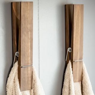 Two wooden pegs holding towels