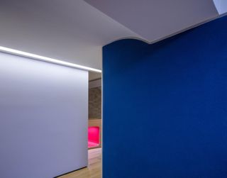 Playroom spaces flow into one another with walls accentuated in different colours of blue and white.