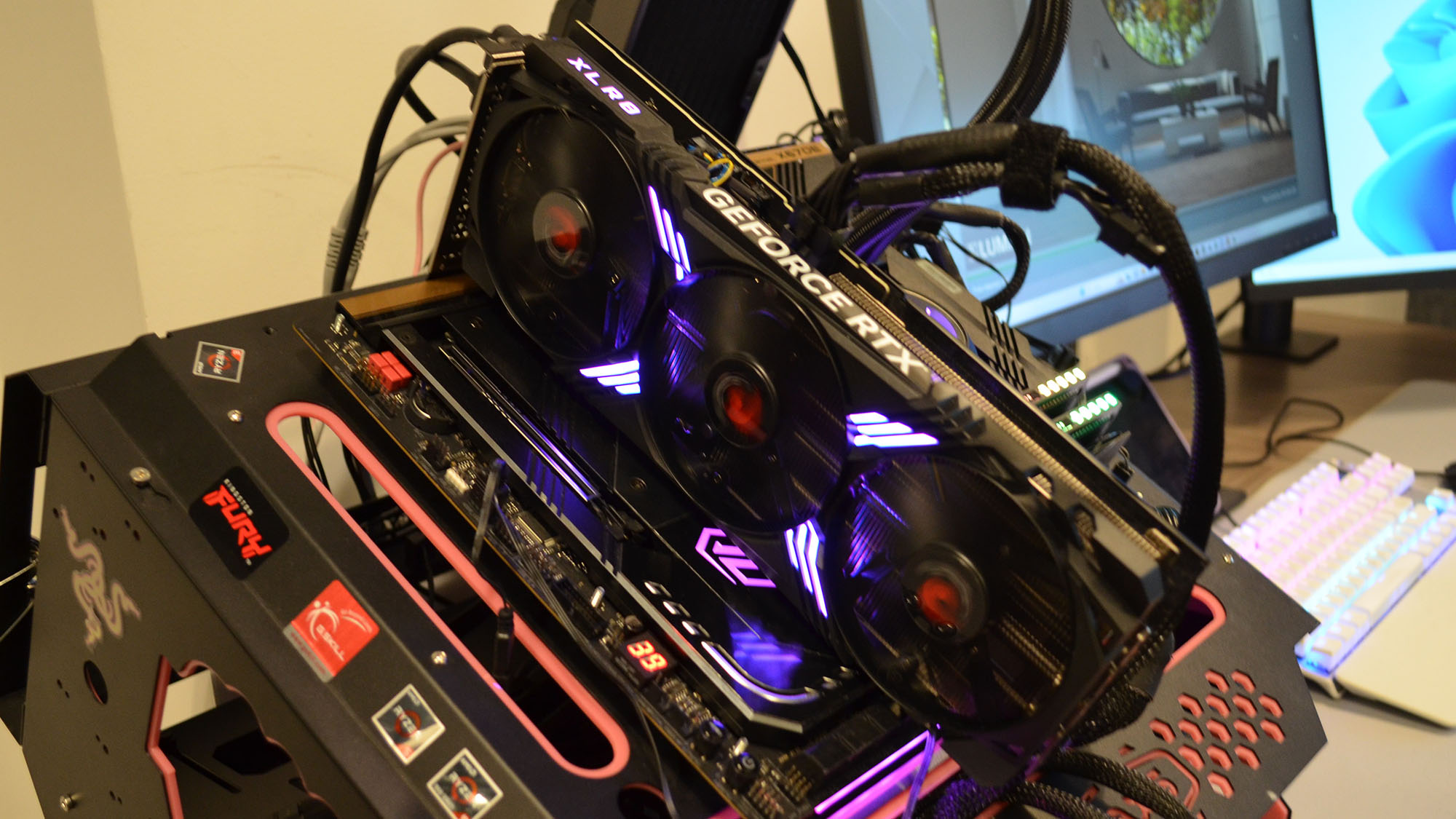 A PNY GeForce RTX 4070 XLR8 running on a test bench in an office