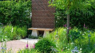 The South Oxfordshire Landscape Garden at RHS Hampton Court Palace Flower Show 2018 with brick terrace and wall inspired by Brunel railway bridge