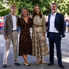 Crown Prince Christian, Princess Isabella, Queen Mary and King Frederik posing with their arms around each other