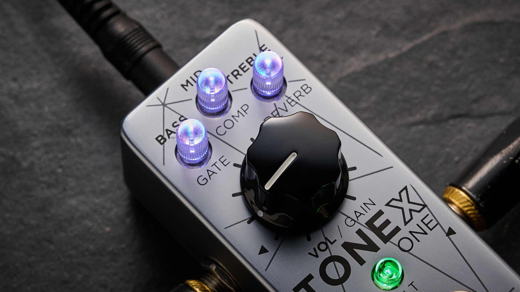 IK Multimedia Tonex One Bass: the mini-pedal offers amp modelling and heaps of tone options and is here photographed against a slate floor.