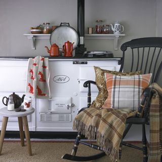 kitchen with black rocking chair and black teapot on wooden stool