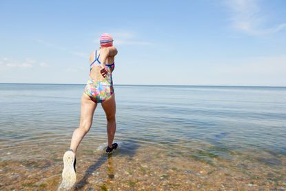 lady jumping into sea