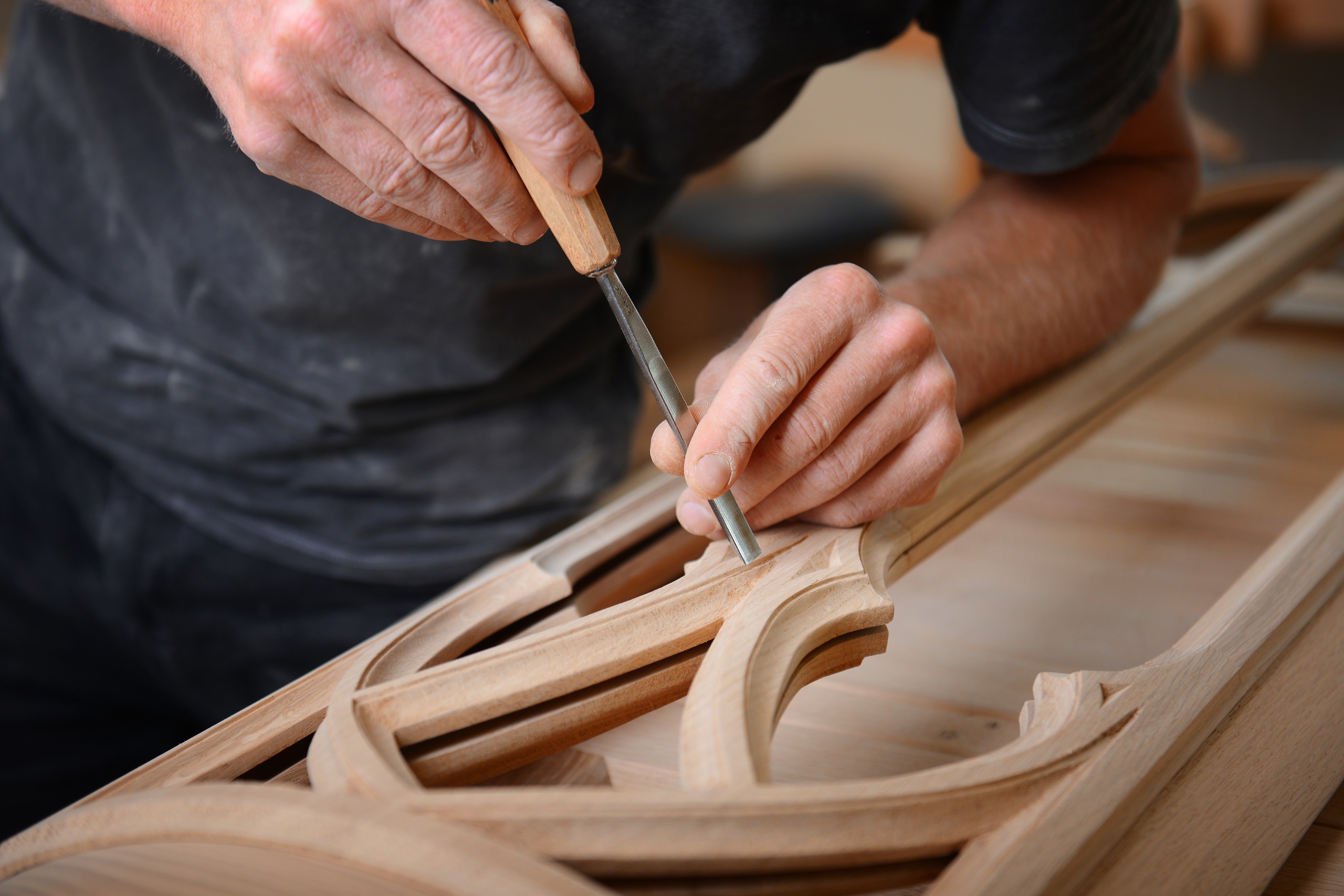 Close-up of a man chiselling at a piece of wood