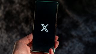 X logo on a phone screen