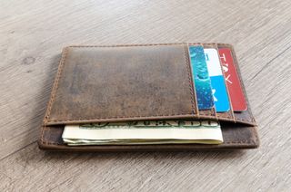 wallet holding a few credit cards and cash