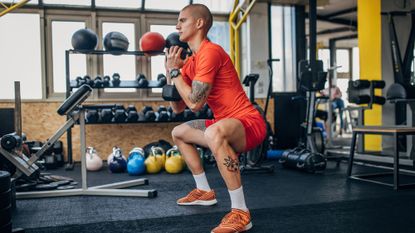 Man doing a dumbbell goblet squat