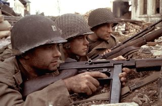 three soldiers hiding and aiming their guns in a Saving private ryan film still