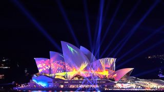 Sydney Opera House lit up in colored lights