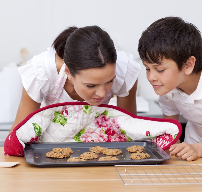 Mom and son smelling fresh cookies