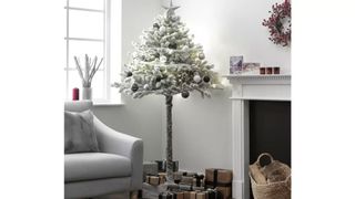 snowy half Christmas tree as ideal solution as a cat proof Christmas tree idea