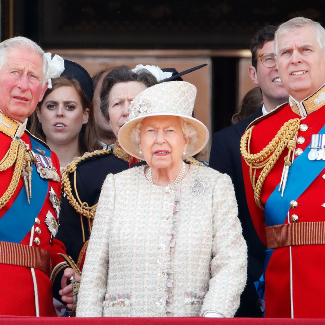 King Charles and Prince Andrew wear red military uniforms as they stand on the Buckingham Palace balcony with Queen Elizabeth II