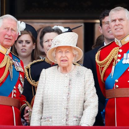 King Charles and Prince Andrew wear red military uniforms as they stand on the Buckingham Palace balcony with Queen Elizabeth II