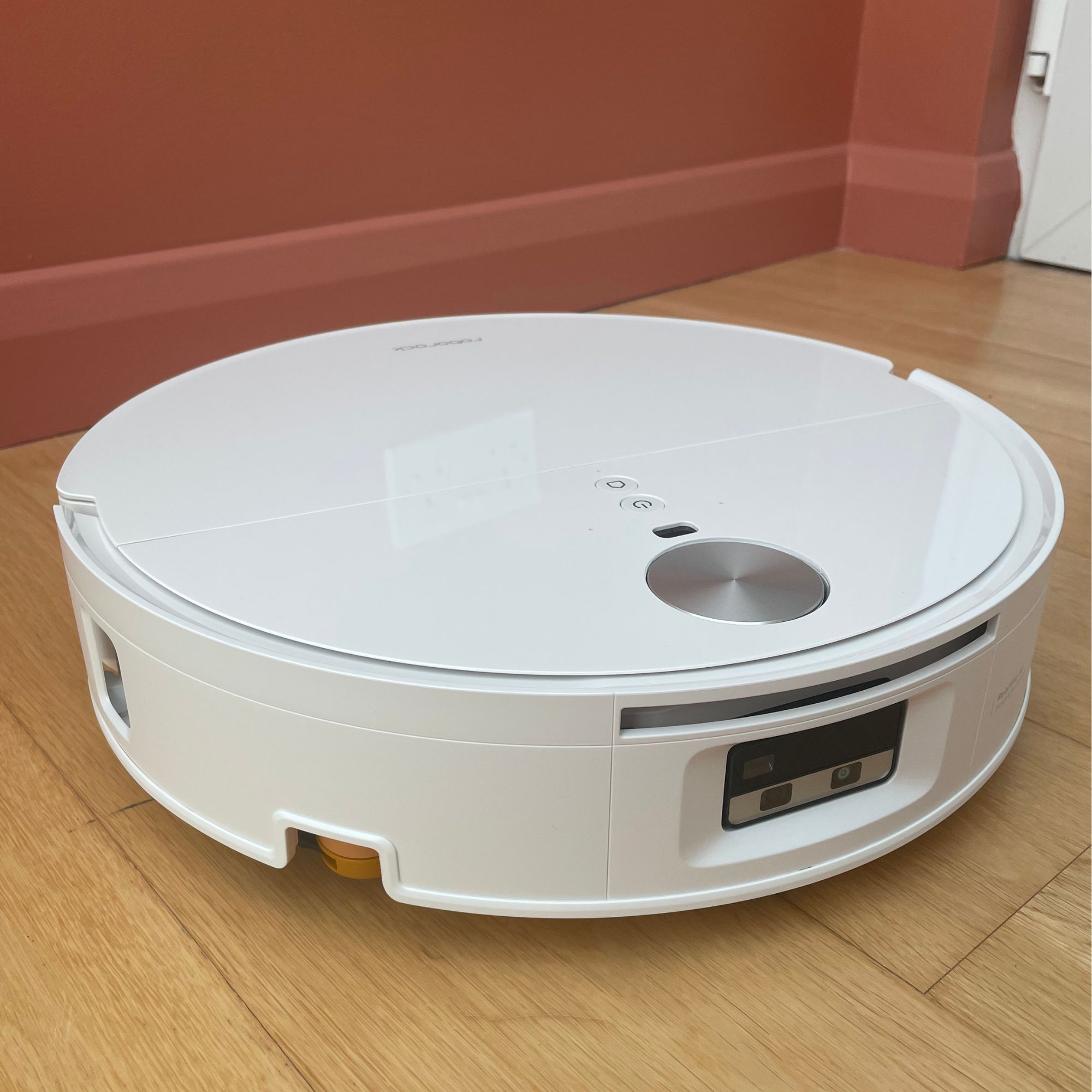 White Roborock Qrevo Edge 2 Flow Robot Vacuum bot sitting on wooden flooring in front of a pink wall