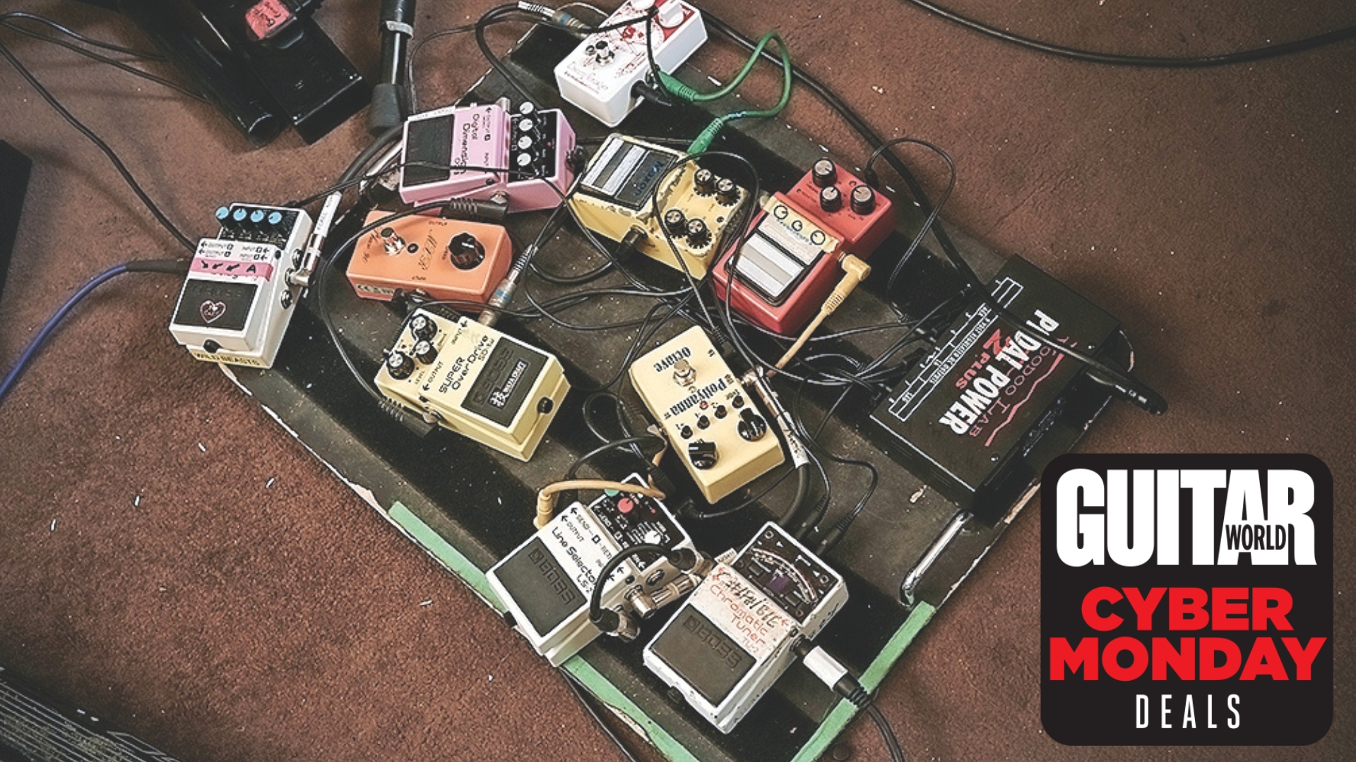 A picture of a messy pedalboard lying on a dirty rehearsal room floor