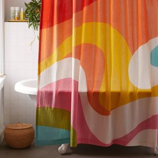 Rainbow swirl shower curtain over a tub from Urban Outfitters