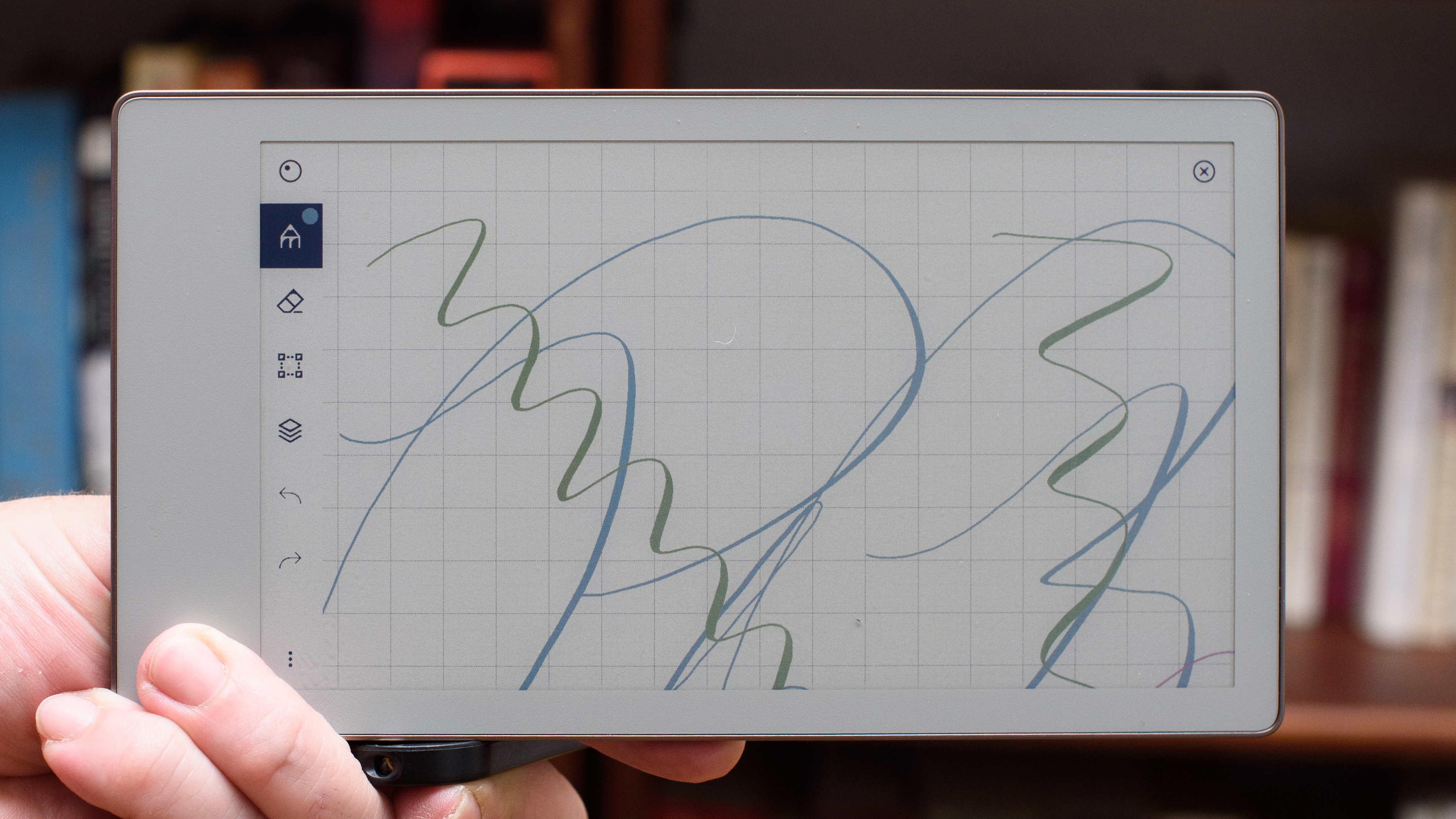 reMarkable Paper Pro Move tablet in front of a library of books, showing various writing screens and comparing the size to a Moleskine notebook