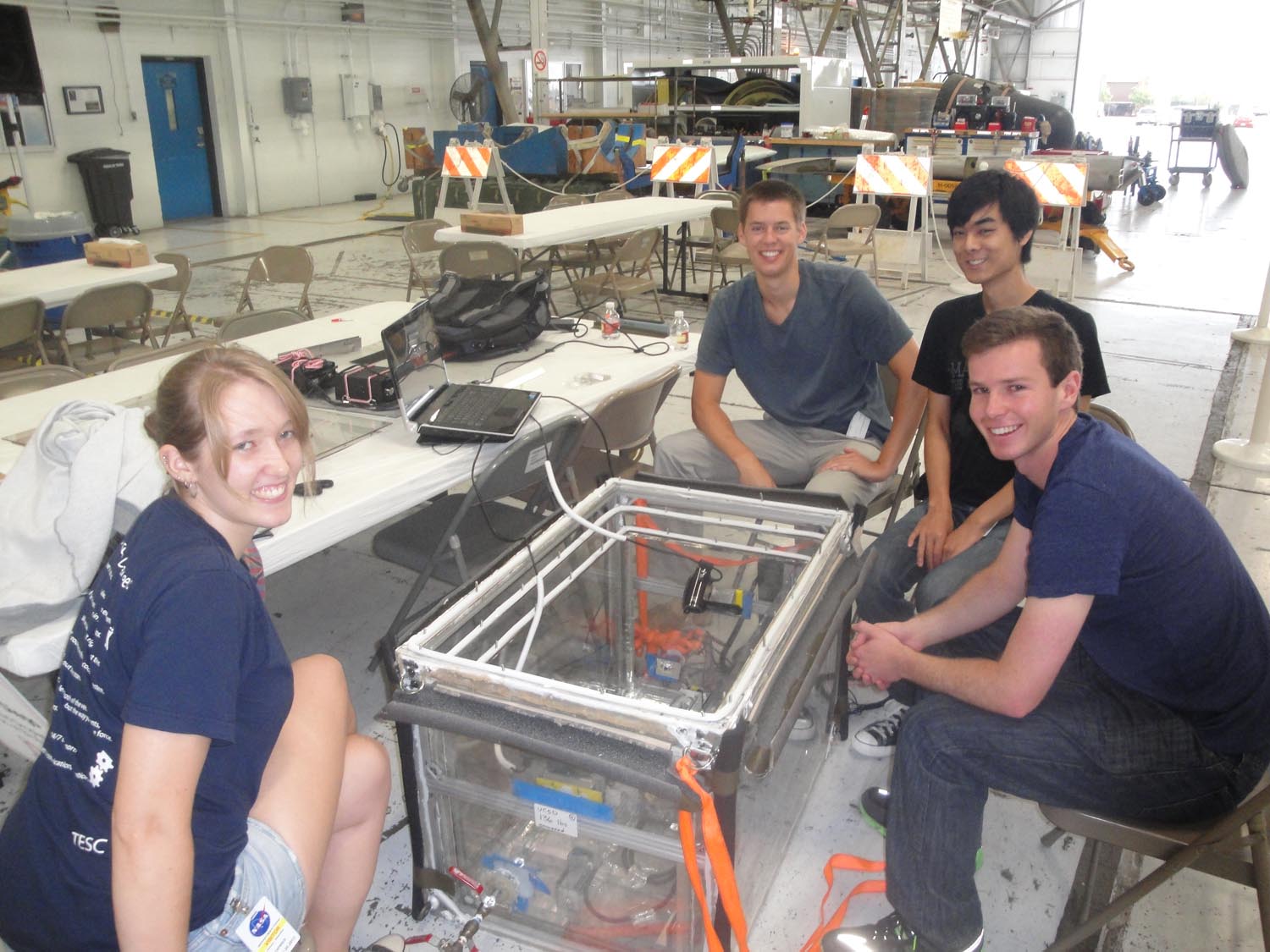 Members of the University of California, San Diego Microgravity Team wait with their biofuel fire experiment apparatus ahead of a weightless flight as part of NASA's Microgravity University Program. Image taken July 17, 2013 at Ellington Field, Houston. They are: (clockwise from top left): Jack Goodwin, Victor Hong, team leader Sam Avery, and Daneesha Kenyon.