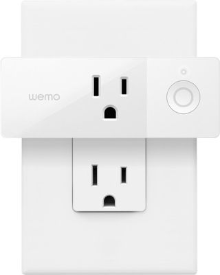 Wemo mini smart plug installed in a power outlet on a white background