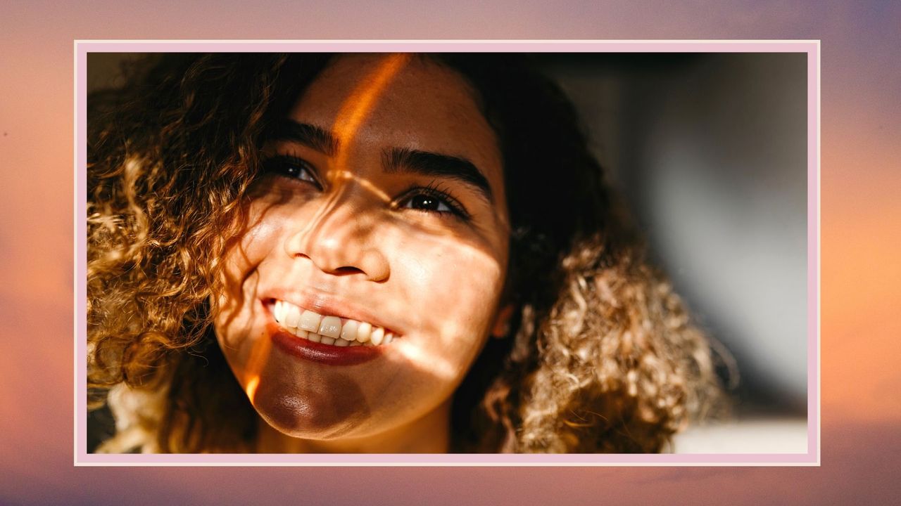 close-up portrait of young woman smiling in sunlight