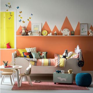 childrens bedroom with table and bed