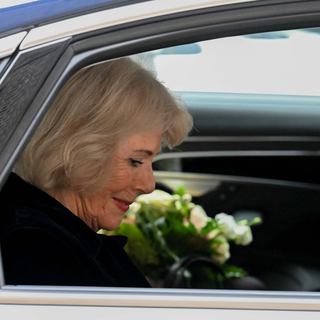 Queen Camilla riding in a car wearing black