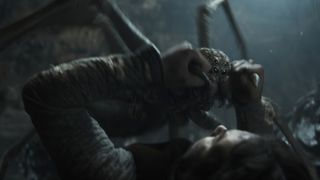 A shot of a young Shelob fighting Isildur in her lair in The Rings of Power season 2