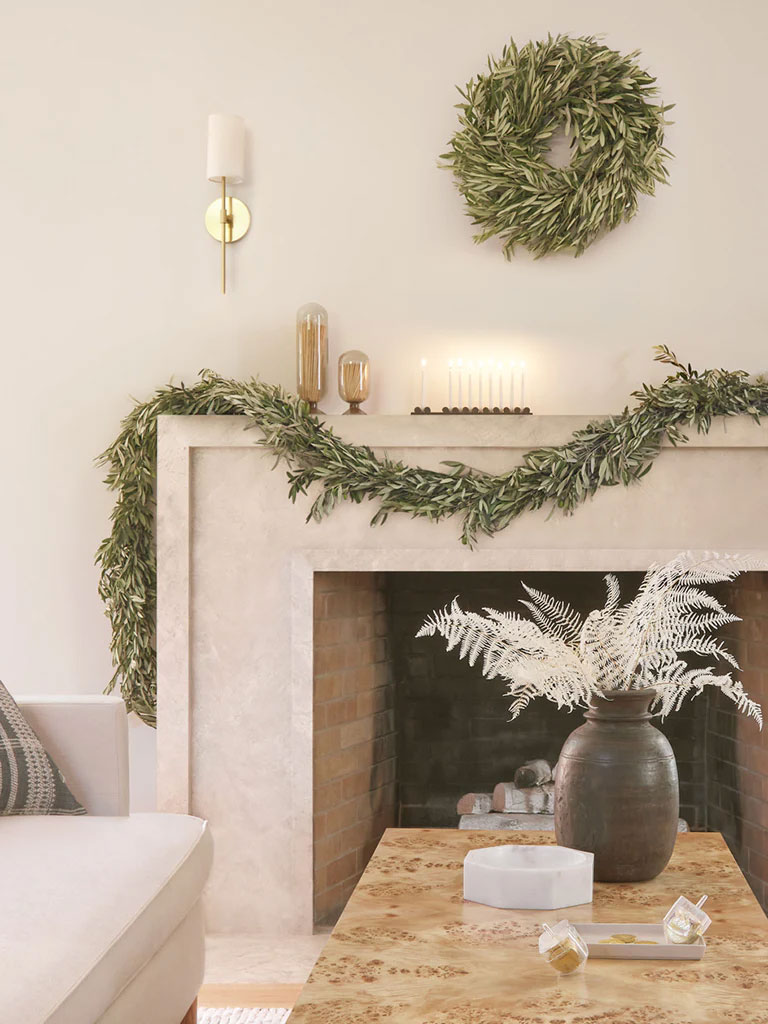 Sustainable christmas decor, minimalist living room with garland and wreath