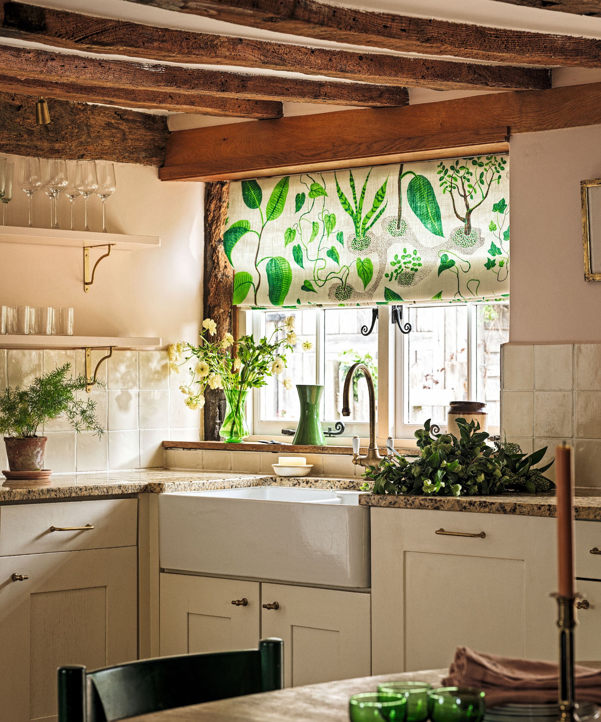 Country kitchen with cream cabinets and wooden beams