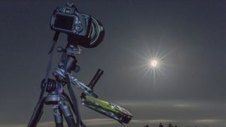 How to photograph a solar eclipse: image shows camera and tripod set up to photograph a lunar eclipse