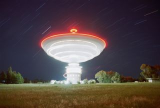 The radio telescope at Parkes Observatory in Australia revolves at night during routine maintenance.