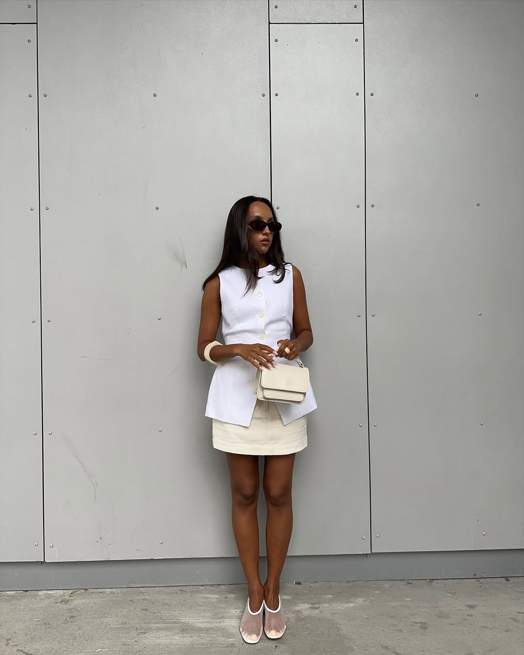 @ingridedvinsen wears a tailored pale yellow mini skirt with a white waistcoat and mesh pumps