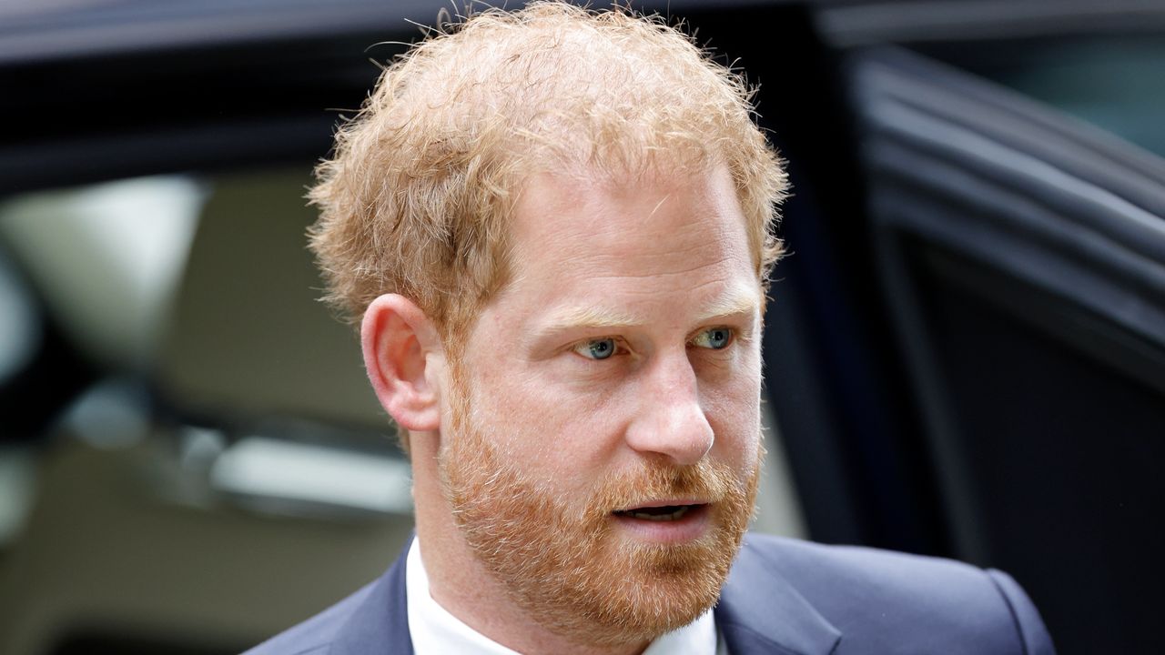 Prince Harry emerging from a car