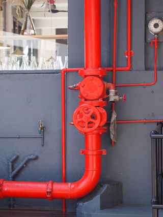 Fire-engine red pipe up a wall