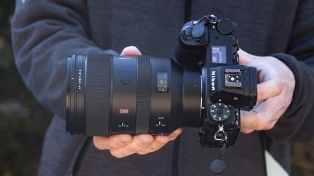 Viltrox 135mm F1.8 Lab lens for Nikon Z-mount, in the hand, attached to a Nikon Z6 II