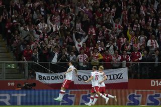 Robert Lewandowski, left, celebrates after scoring in the qualifier win over Albania