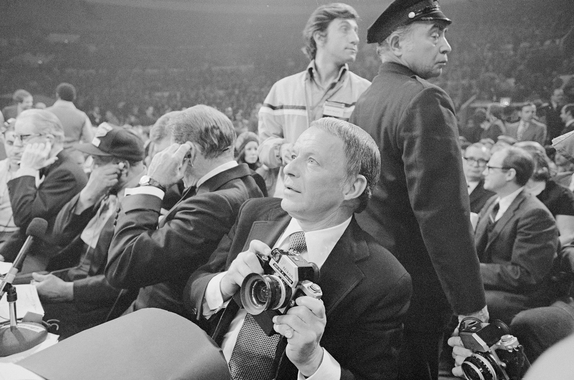 Singer-actor Frank Sinatra turns cameraman for the Frazier-Ali fight, March 8, and national magazine (life) featured his photos in their next issue. Singer-actor-photographer Sinatra has announced his planned retirement from Show Biz, but now that he's achieved success in three fields, why not four? He says he'll probably try his hand at writing.
