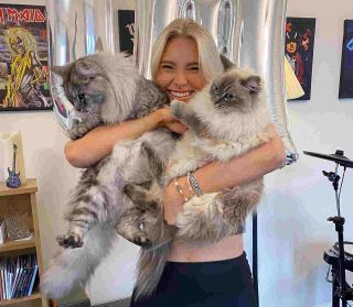 Sophie Lloyd holding her cats Luna and Jaxx