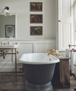 bathroom with white walls with panelling and freestanding bath