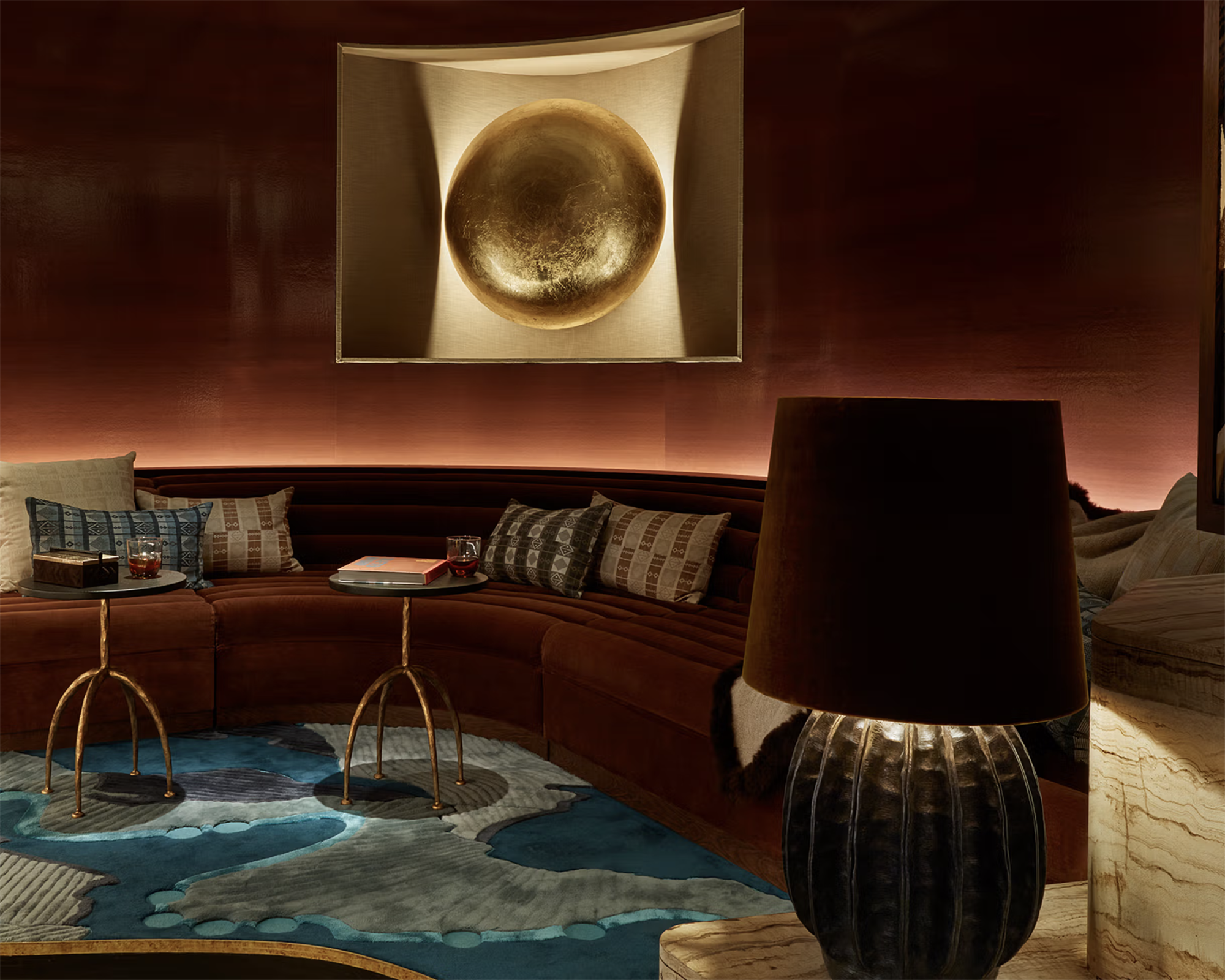 rust colored living room with curved sofa and warm lighting