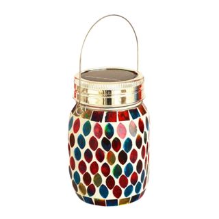 A gold lantern with a multicolored mosaic pattern and a gold looped handle