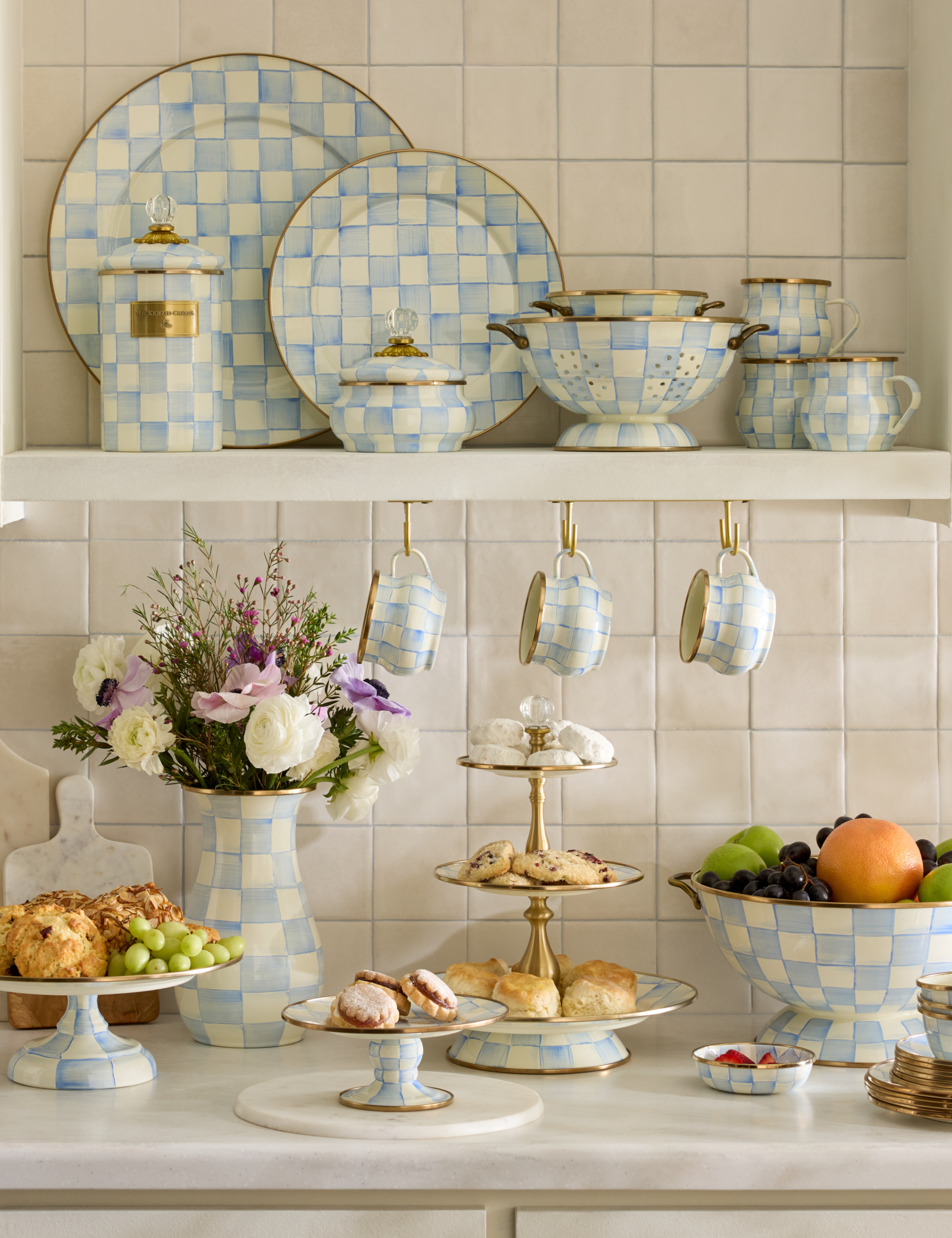 Mackenzie-Childs' new 'Sky Check' tableware and home essentials collection styled in light, bright kitchen with fresh fruit and pastries.